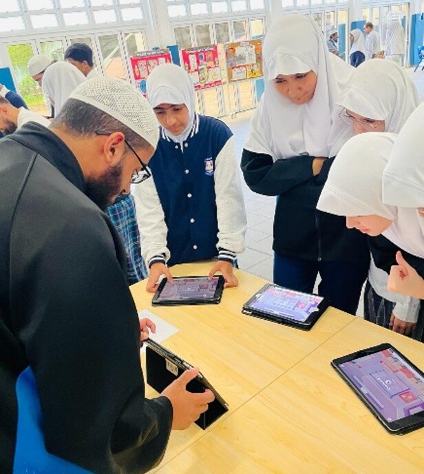 Students engaging in Islamic Trivia using digital tablets