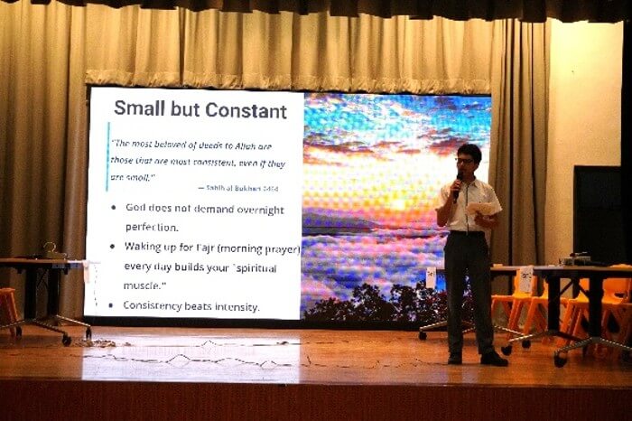 Islam Ambassador student delivering a talk on stage